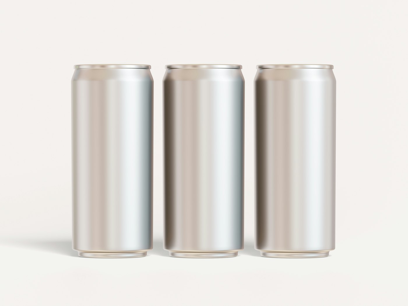 Three plain brushed aluminum cans on a cream background